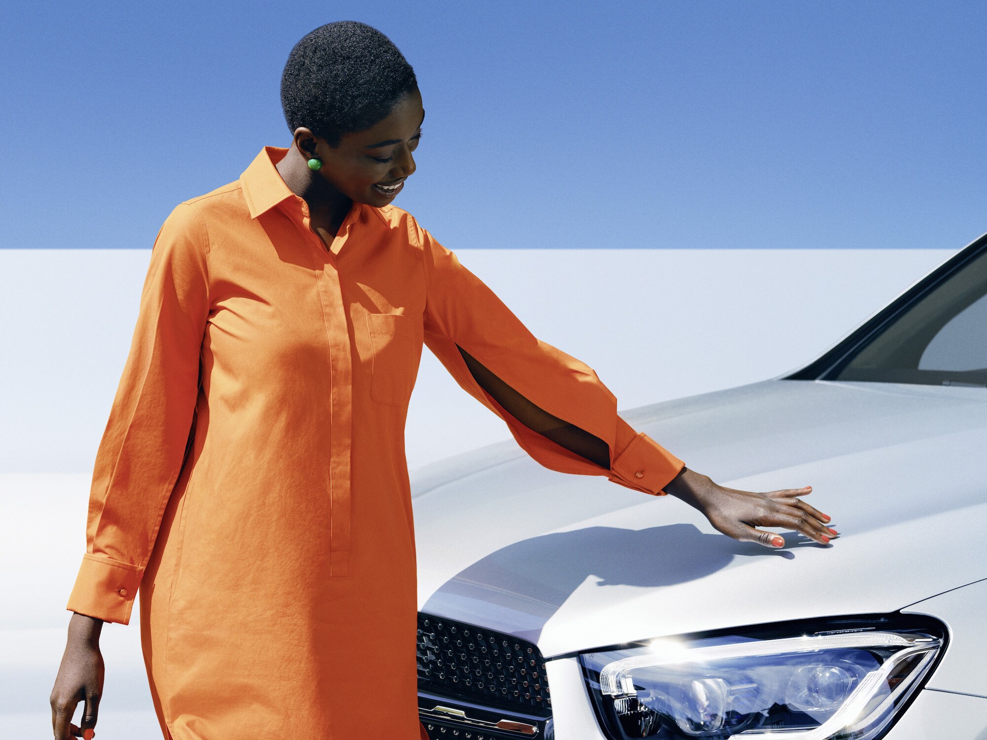 A person is touching her Mercedes.