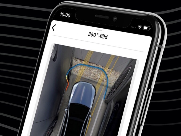 Per Mercedes me Remote Parking App auf dem Smartphone und der 360°-Ansicht wird ein Mercedes-Benz bequem in eine enge Parklücke gesteuert. 