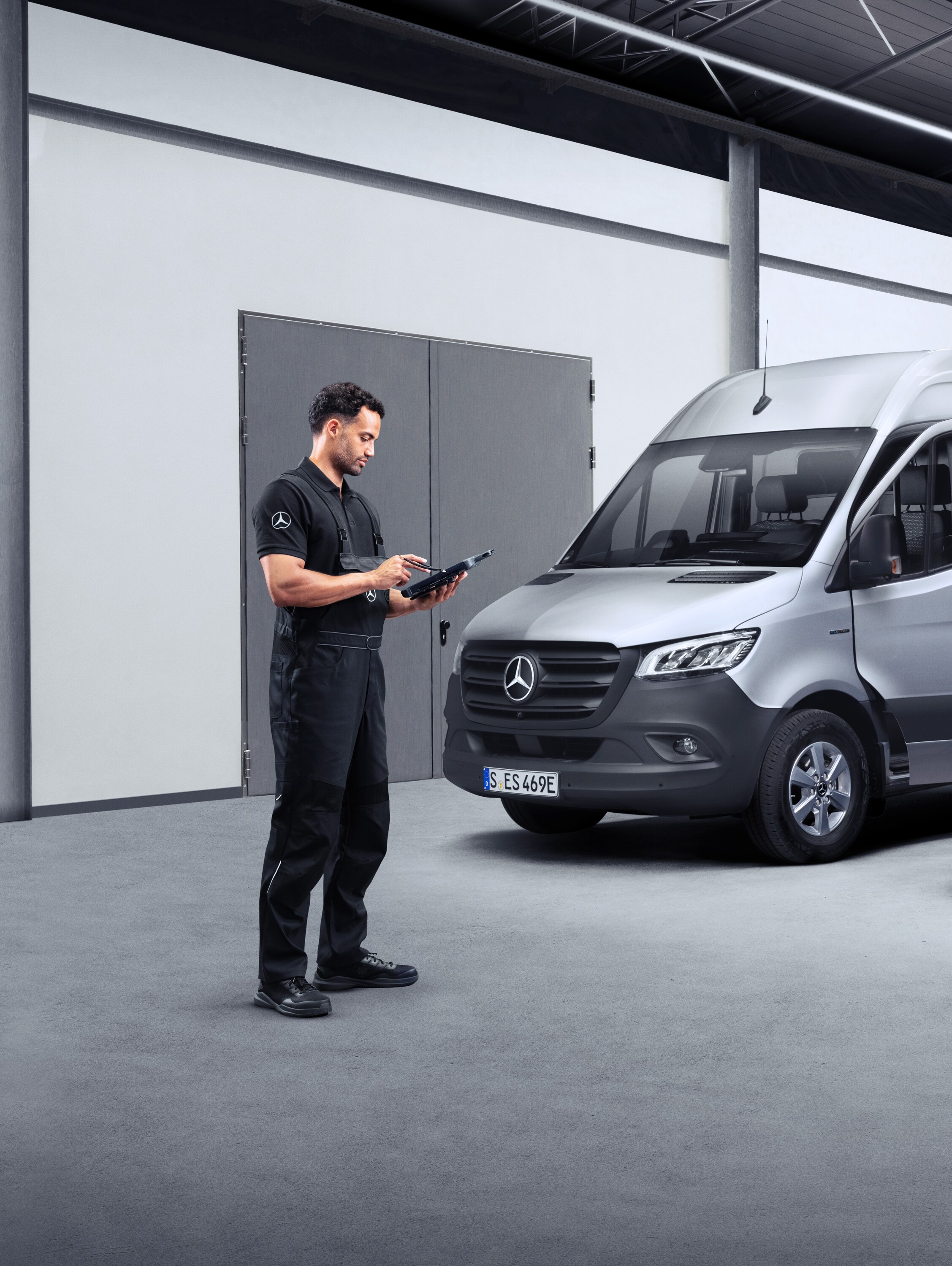 Ein Techniker arbeitet mit einem Tablet vor zwei Elektrotransportern